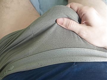 The guy strokes his dick through gray panties